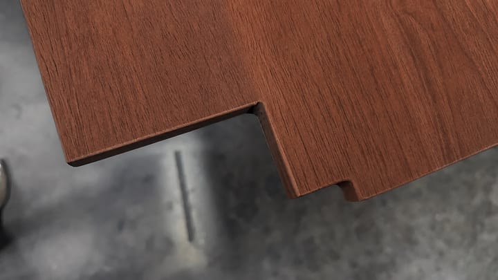 Close-up of a precisely shaped dark Nyatoh solid-wood edge detail